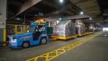 AET with four cargo dollies inside Cathay Cargo Terminal