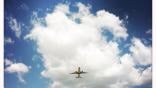 airplane flying among clouds